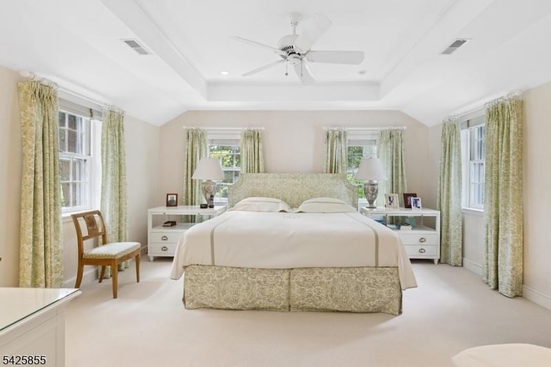 21 Hardwell Road Short Hills, NJ 07078 - Photo 36 of 50 a spacious bedroom with a bed and a chandelier