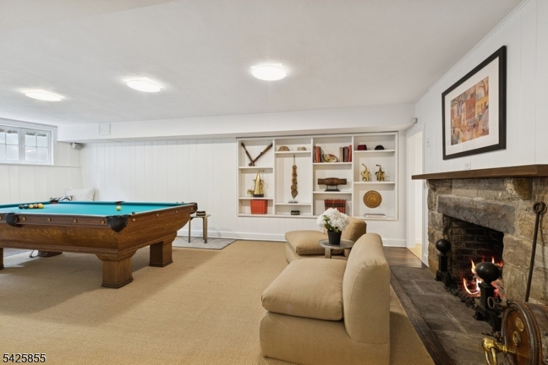 21 Hardwell Road Short Hills, NJ 07078 - Photo 43 of 50 a living room with furniture a fireplace and a flat screen tv