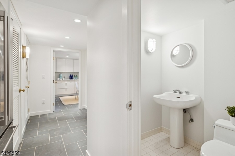 21 Hardwell Road Short Hills, NJ 07078 - Photo 47 of 50 a bathroom with a sink mirror toilet and shower