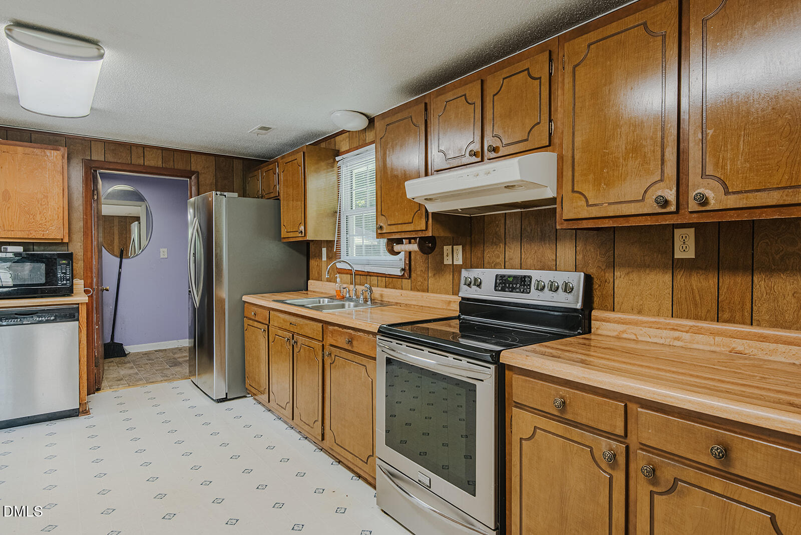 1302 Blacksmith Road Efland, NC 27243 - Photo 8 of 46 a kitchen with stainless steel appliances granite countertop a refrigerator a stove and a sink