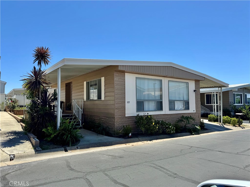 23301 Ridge Rte Drive, Unit 109 Laguna Hills, CA 92653 - Photo 1 of 46 a front view of a house with garden