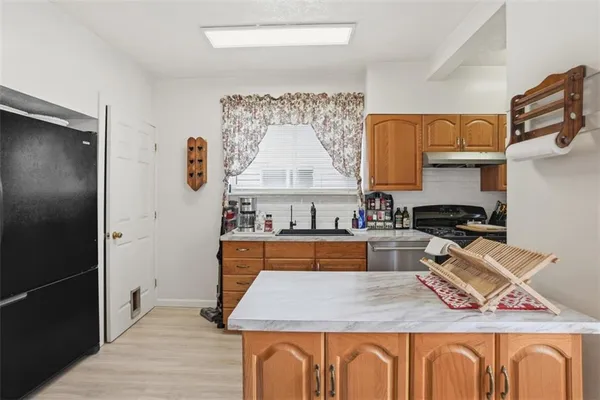 a kitchen with stainless steel appliances granite countertop a stove and a refrigerator