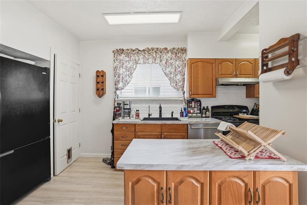 206 Third Street Pittsburgh, PA 15225 - Photo 11 of 25 a kitchen with stainless steel appliances granite countertop a stove and a refrigerator
