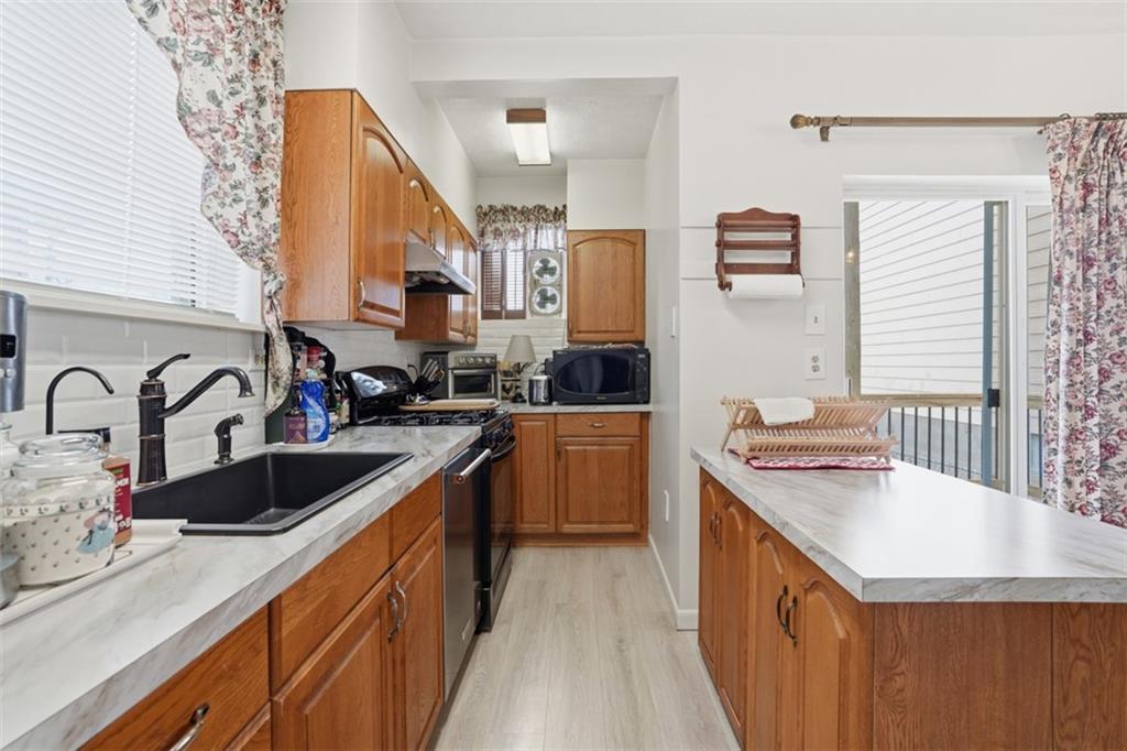 206 Third Street Pittsburgh, PA 15225 - Photo 13 of 25 a kitchen with a sink stove and cabinets