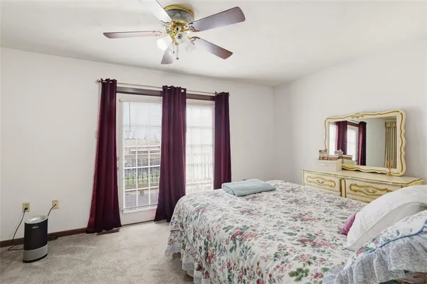a bedroom with a large bed and a chandelier