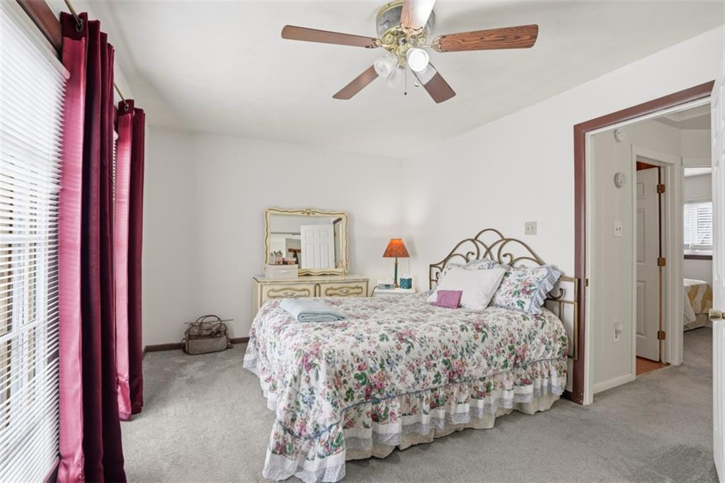 206 Third Street Pittsburgh, PA 15225 - Photo 16 of 25 a bedroom with a bed and a chandelier