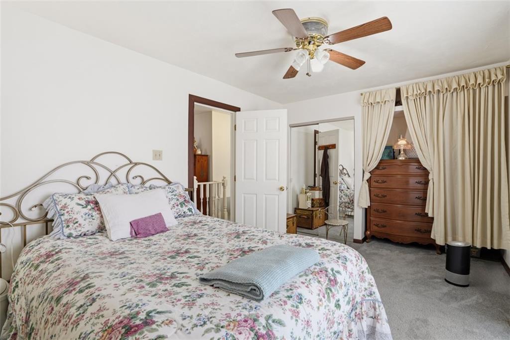 206 Third Street Pittsburgh, PA 15225 - Photo 17 of 25 a bedroom with a bed and a chandelier