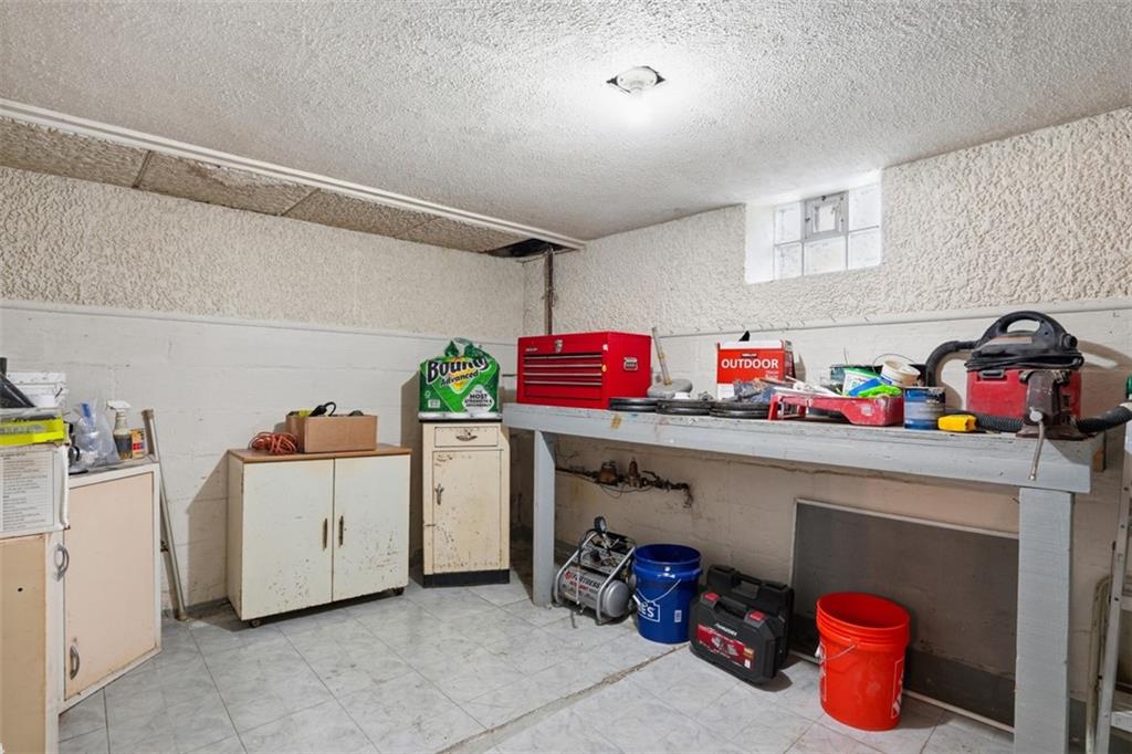 206 Third Street Pittsburgh, PA 15225 - Photo 24 of 25 a utility room with lots of clutter and white cabinets