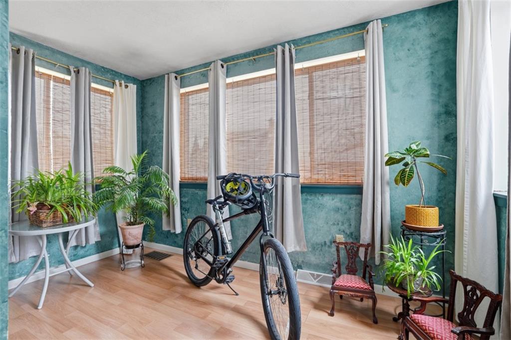 206 Third Street Pittsburgh, PA 15225 - Photo 8 of 25 a dining room with furniture potted plants and wooden floor