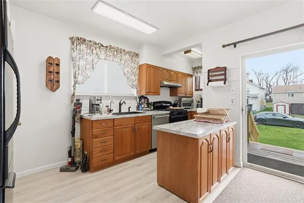 a kitchen with stainless steel appliances granite countertop a sink and a stove