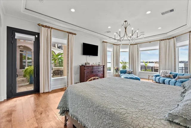 a spacious bedroom with a large bed and a flat screen tv