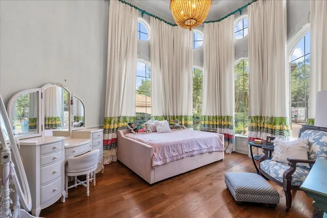 a bedroom with a bed and a large window