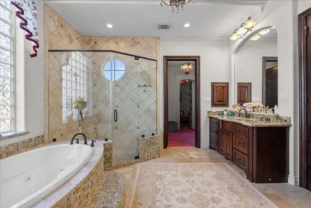 a spacious bathroom with a tub sink shower and mirror