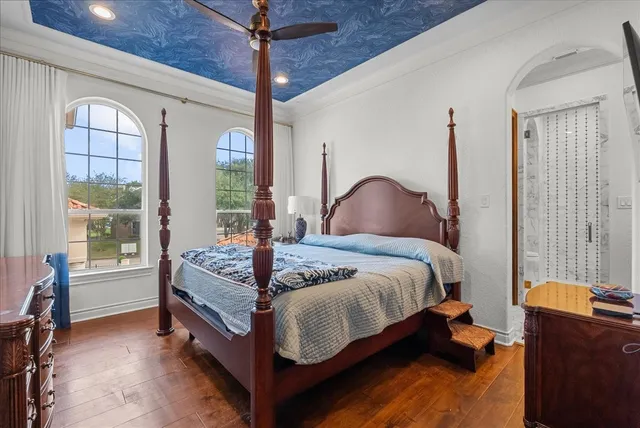 a bedroom with a bed chair and a large window