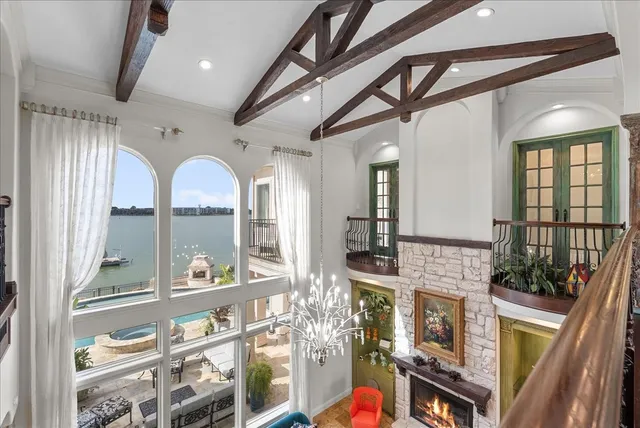 a living room with fireplace furniture and a potted plant