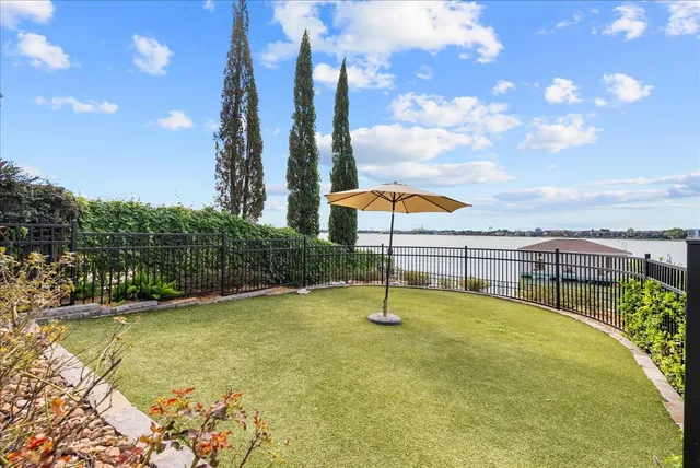 a swimming pool with lawn chairs and palm tree