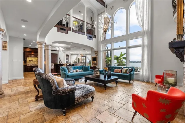 a living room filled with furniture and a chandelier