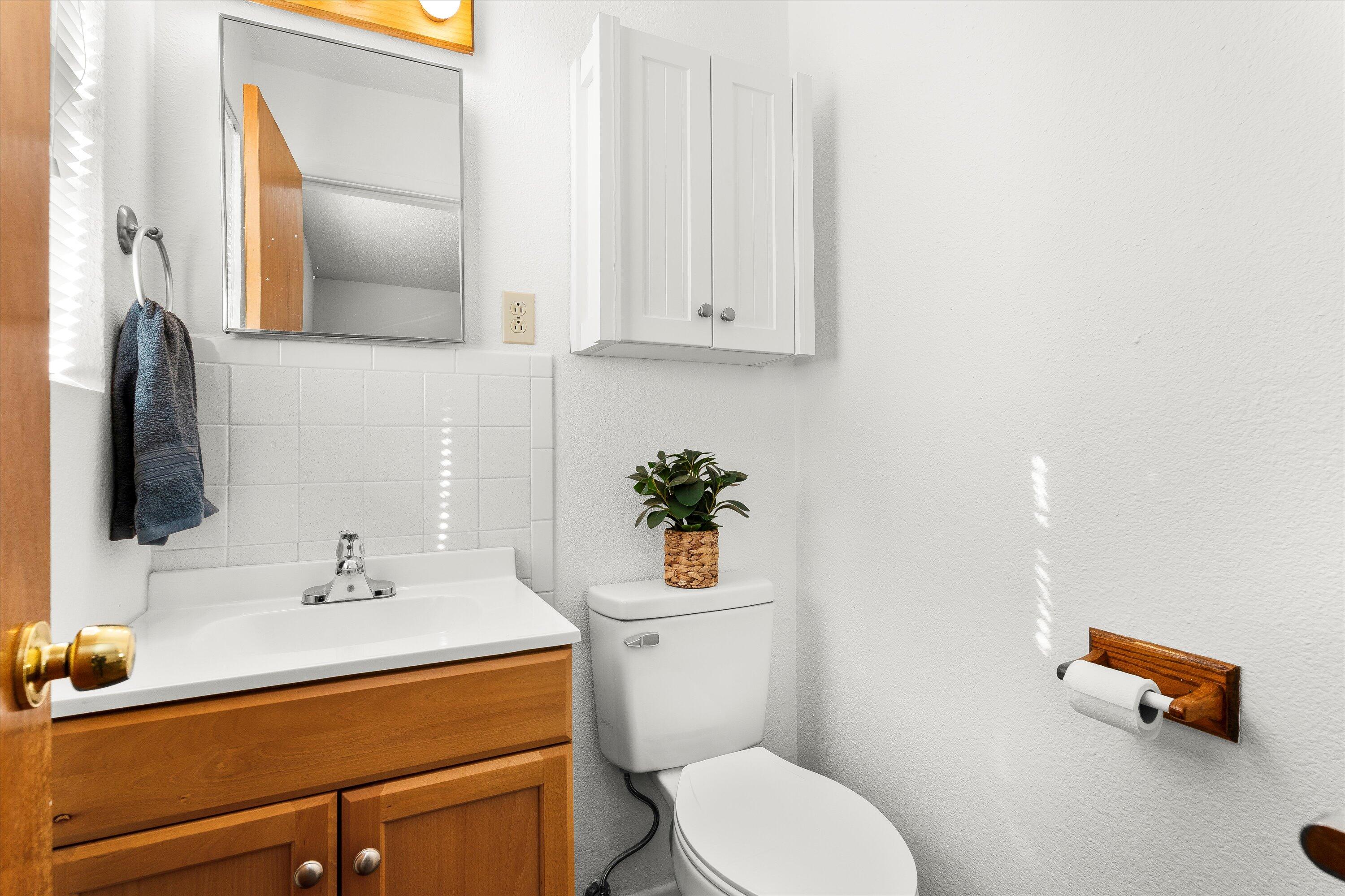 5519 17th Street Lubbock, TX 79416 - Photo 12 of 23 a bathroom with a sink a toilet and mirror