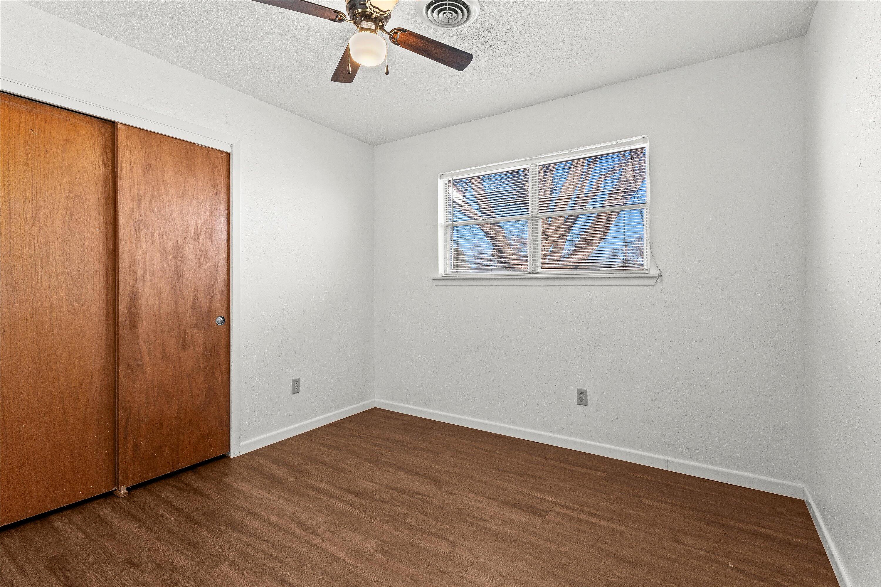 5519 17th Street Lubbock, TX 79416 - Photo 13 of 23 a view of empty room with wooden floor and fan
