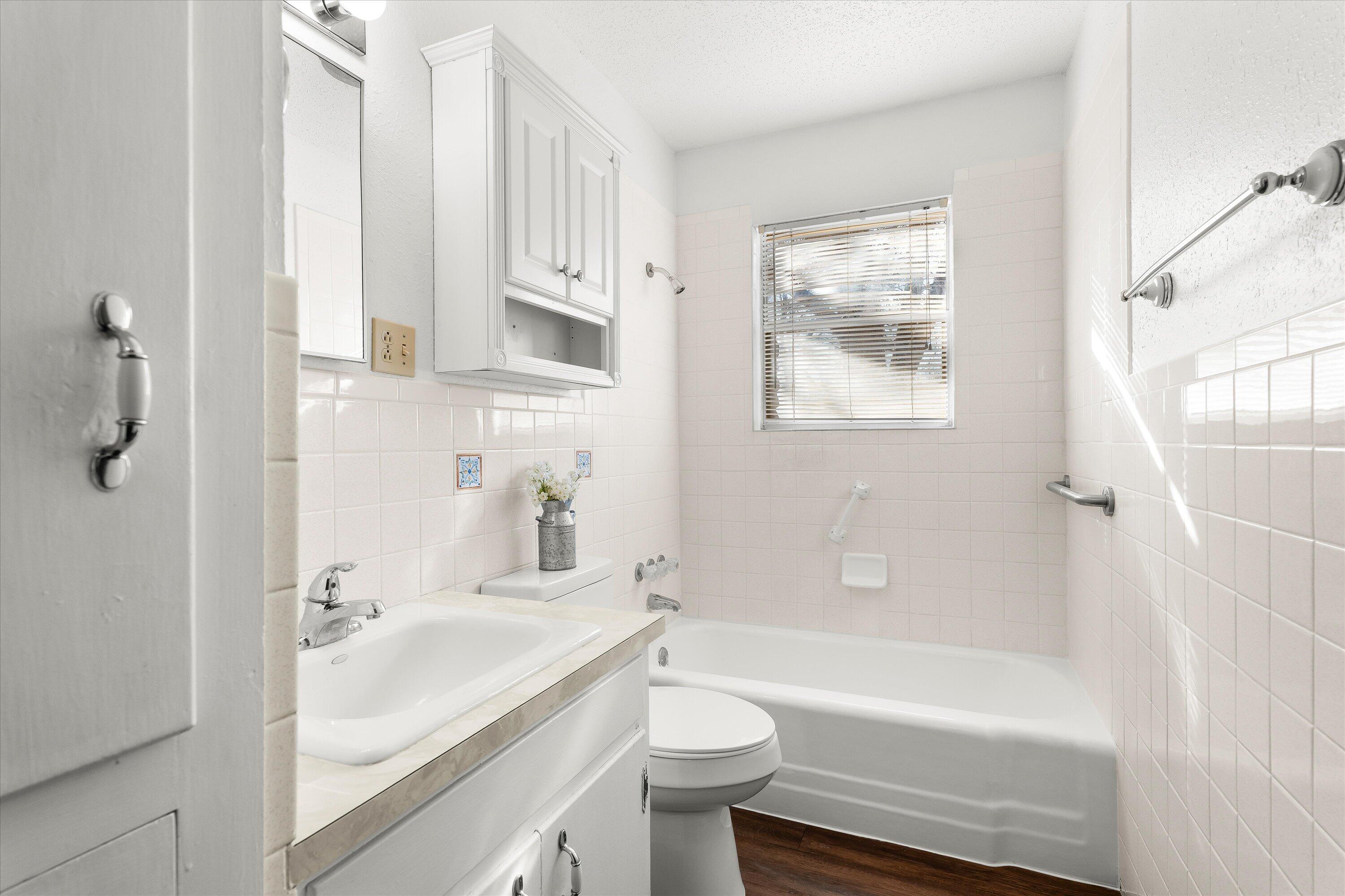 5519 17th Street Lubbock, TX 79416 - Photo 15 of 23 a bathroom with a sink a toilet and bathtub