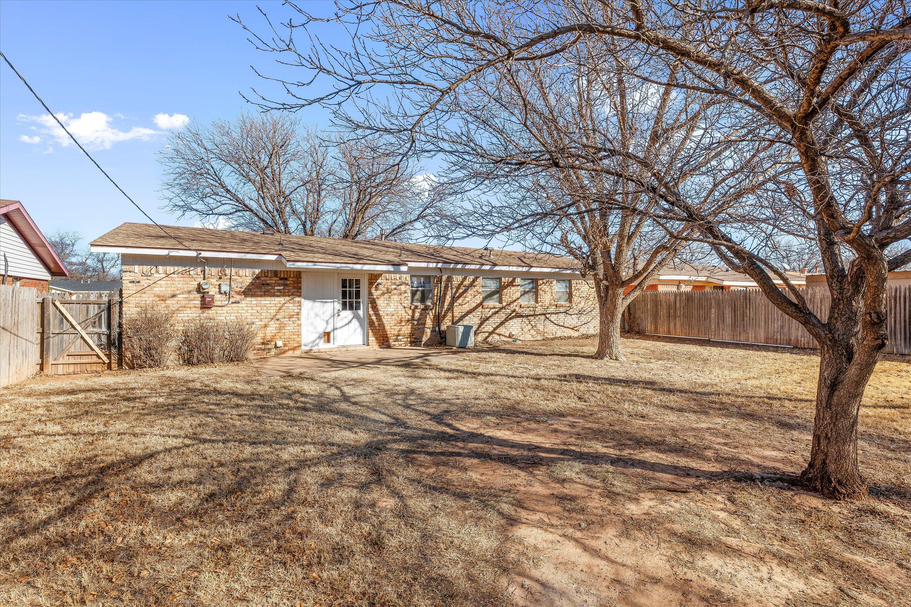5519 17th Street Lubbock, TX 79416 - Photo 20 of 23 a view of a yard with large trees