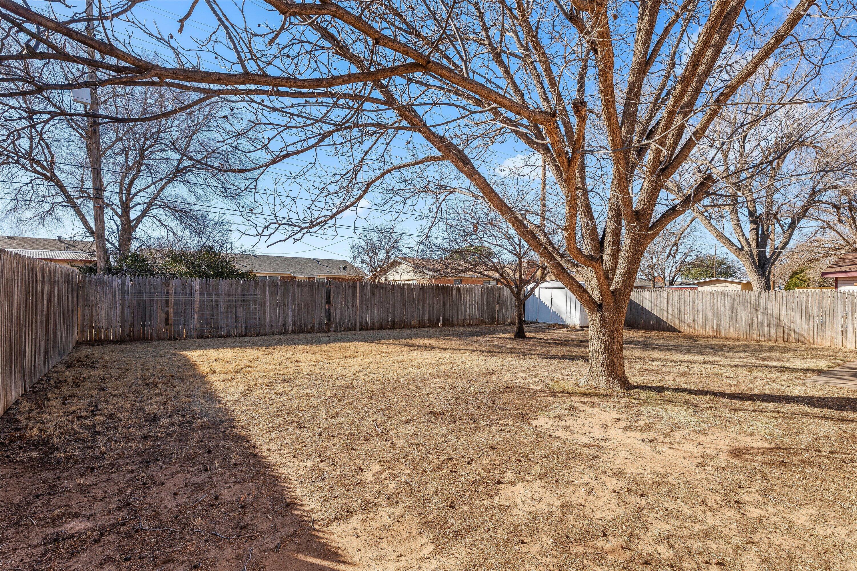 5519 17th Street Lubbock, TX 79416 - Photo 22 of 23 a backyard of a house with lots of green space