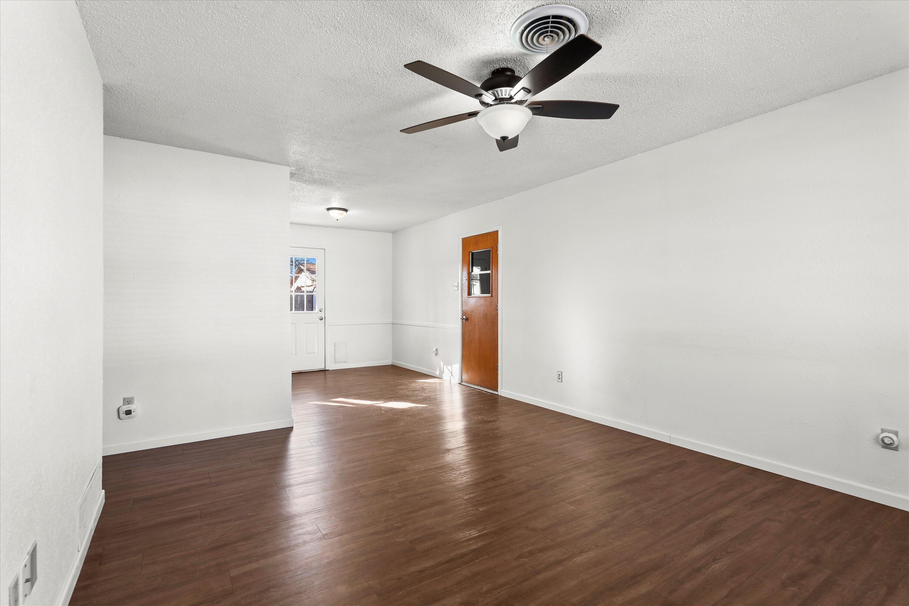 5519 17th Street Lubbock, TX 79416 - Photo 4 of 23 a view of an empty room with wooden floor