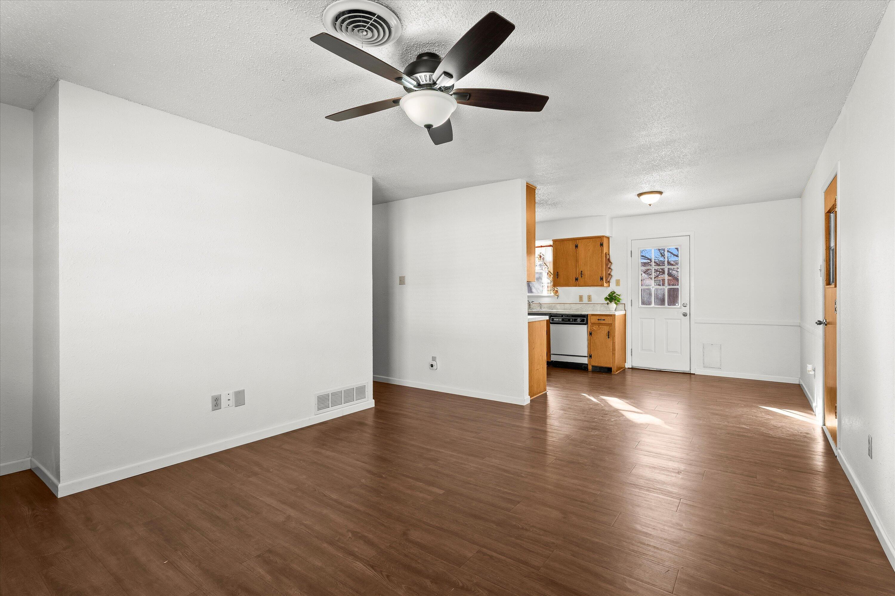5519 17th Street Lubbock, TX 79416 - Photo 5 of 23 an empty room with wooden floor and a ceiling fan