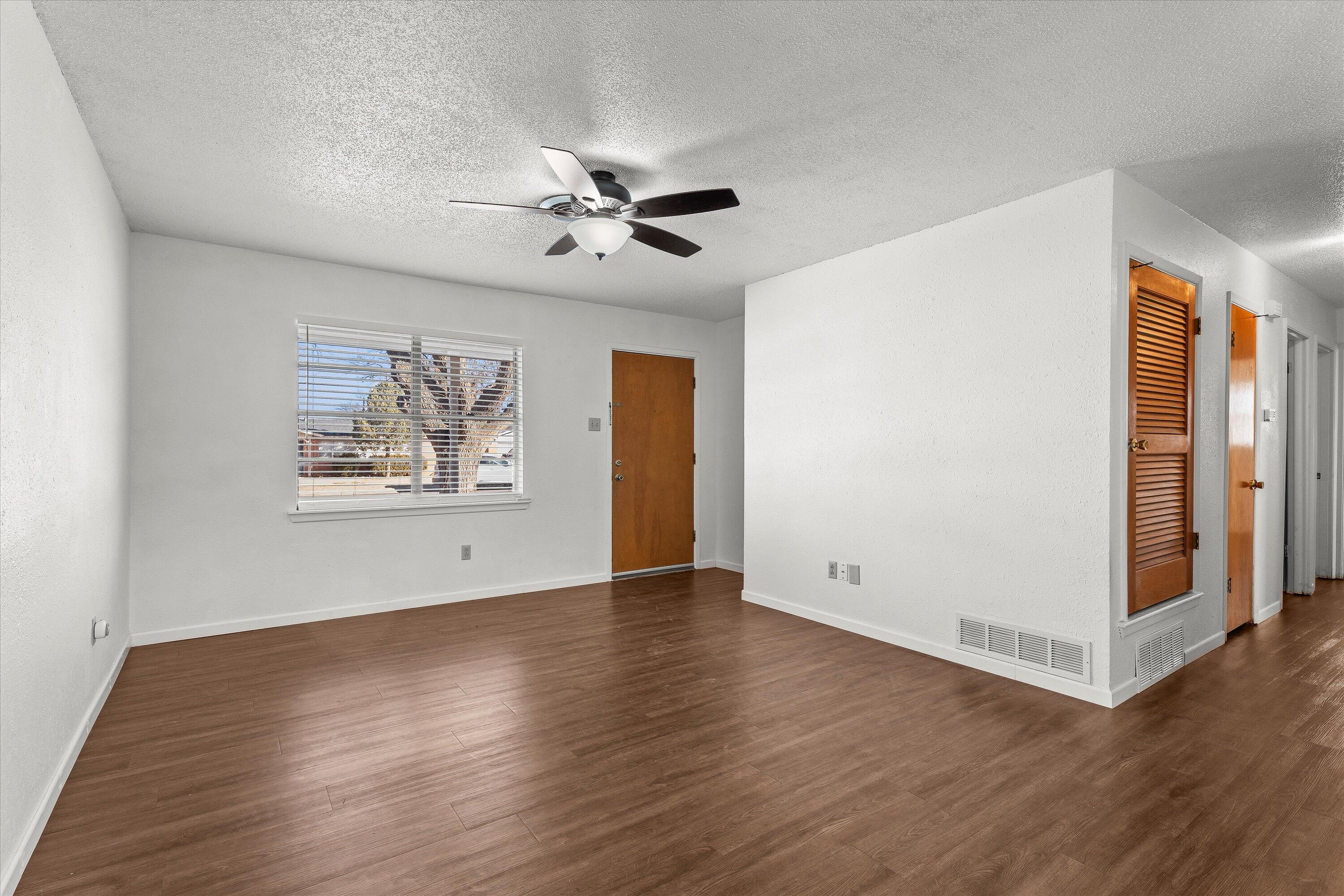 5519 17th Street Lubbock, TX 79416 - Photo 6 of 23 a view of an empty room with wooden floor
