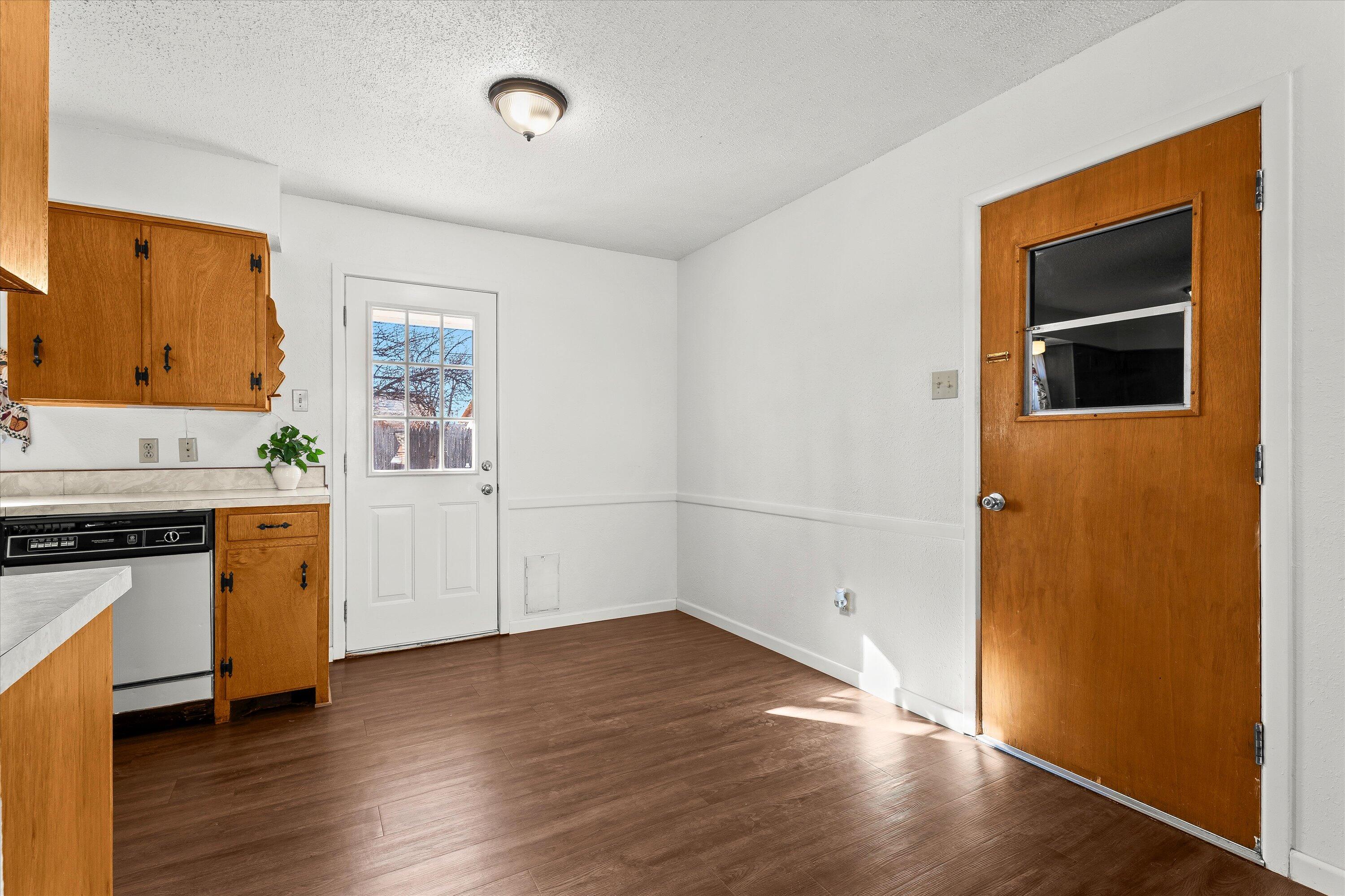 5519 17th Street Lubbock, TX 79416 - Photo 9 of 23 a view of a kitchen with wooden floor and electronic appliances