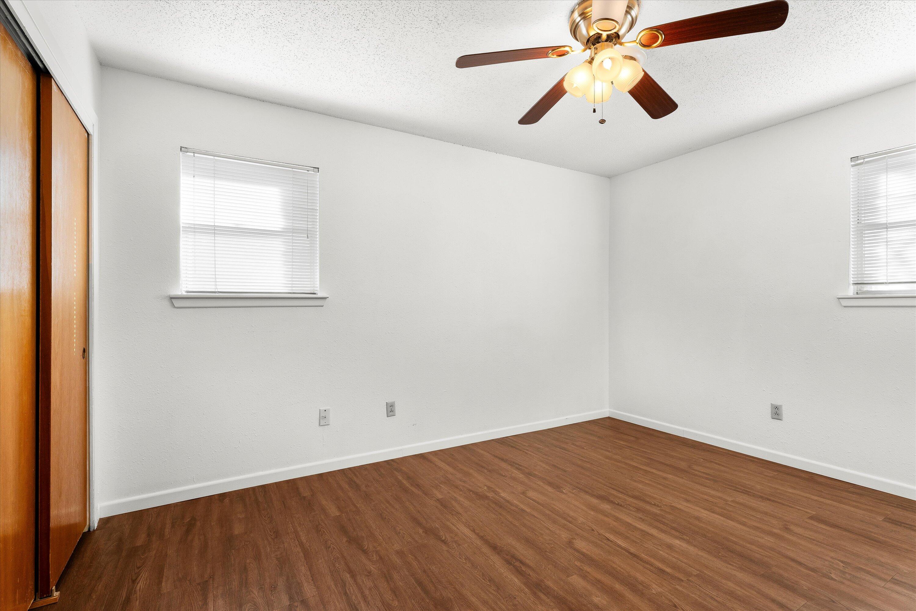 5519 17th Street Lubbock, TX 79416 - Photo 10 of 23 wooden floor in an empty room with a window