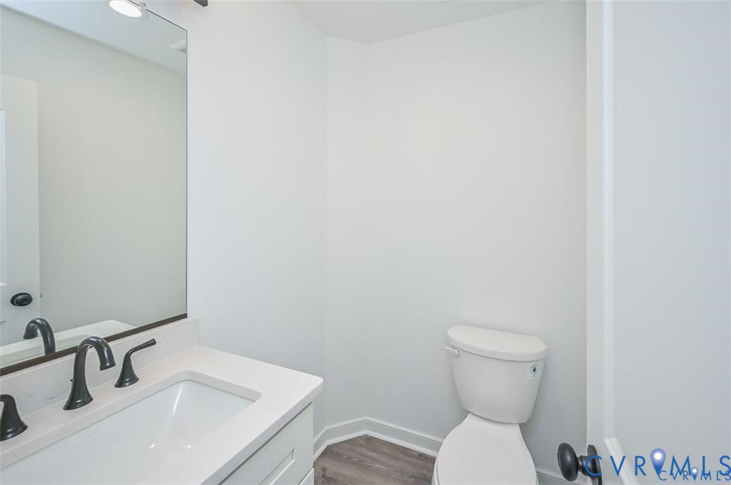 352 Ogden Street West Point, VA 23181 - Photo 12 of 29 a bathroom with a toilet sink and mirror