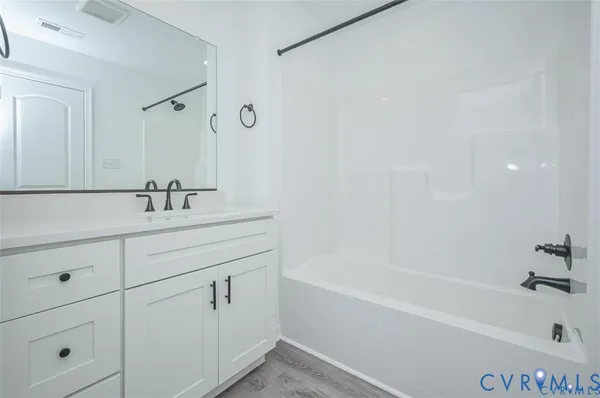 a bathroom with a bathtub and a sink