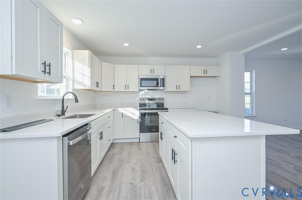 352 Ogden Street West Point, VA 23181 - Photo 10 of 29 a kitchen with a sink a stove and cabinets