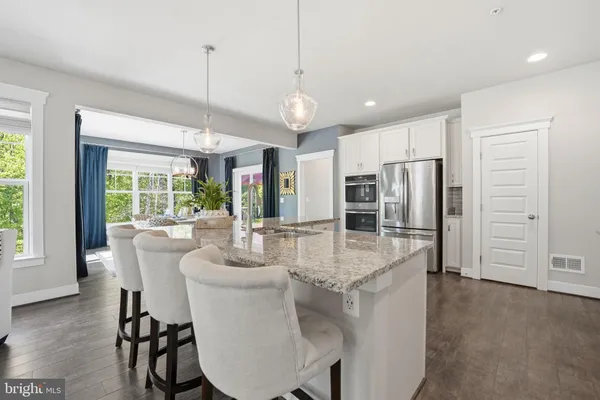 a kitchen with stainless steel appliances granite countertop a stove and cabinets