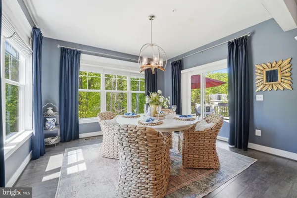 a living room with furniture a fireplace and a dining table