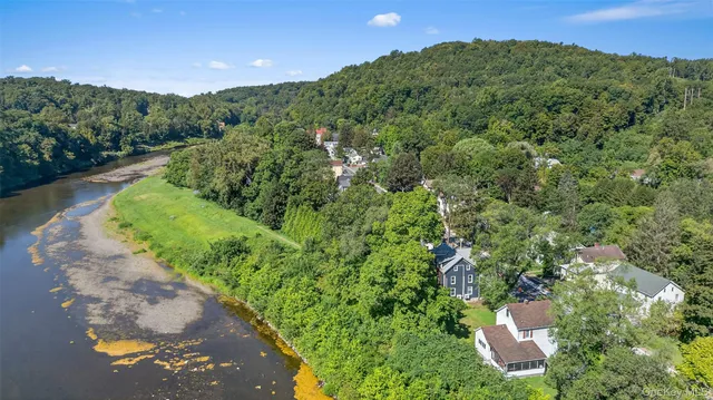an aerial view of a houses with a yard