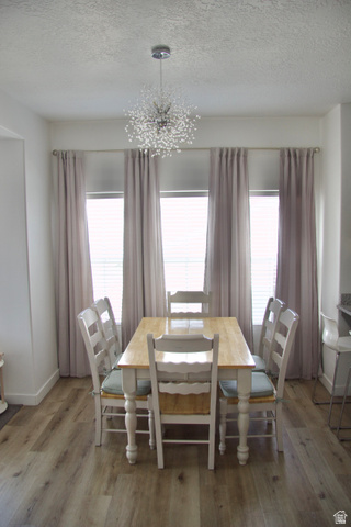 327 West Main Street, Unit 14 Santaquin, UT 84655 - Photo 14 of 20 Dining area featuring a chandelier, a textured ceiling, and wood finished floors
