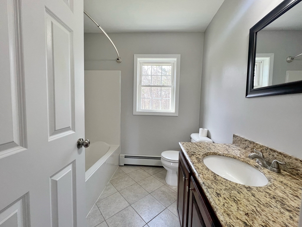 78 Bayberry Hill Road Townsend, MA 01474 - Photo 15 of 26 a bathroom with a granite countertop sink and a mirror