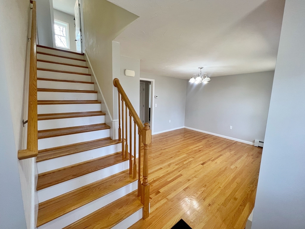 78 Bayberry Hill Road Townsend, MA 01474 - Photo 9 of 26 a view of a livingroom with wooden floor and stairs