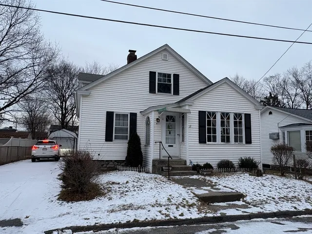 a front view of a house with a chair
