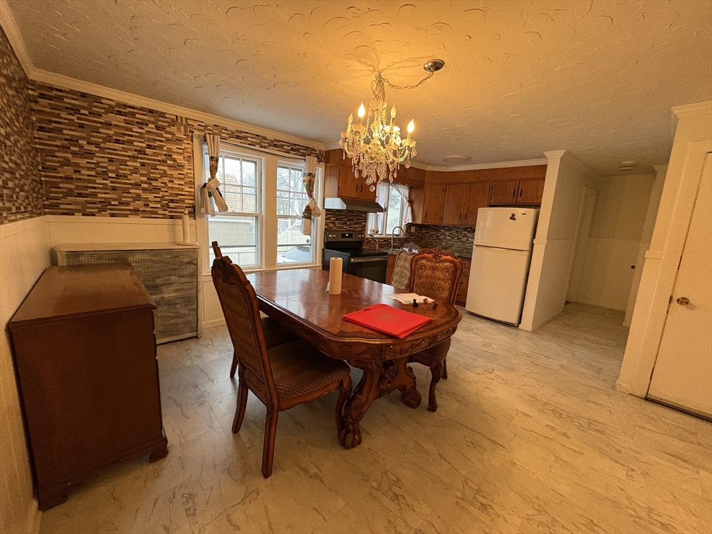 41 Amesbury Street Worcester, MA 01605 - Photo 6 of 17 a dining room with furniture a rug and a chandelier