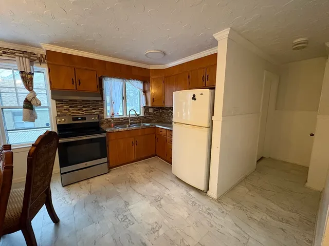 a kitchen with a refrigerator and a stove