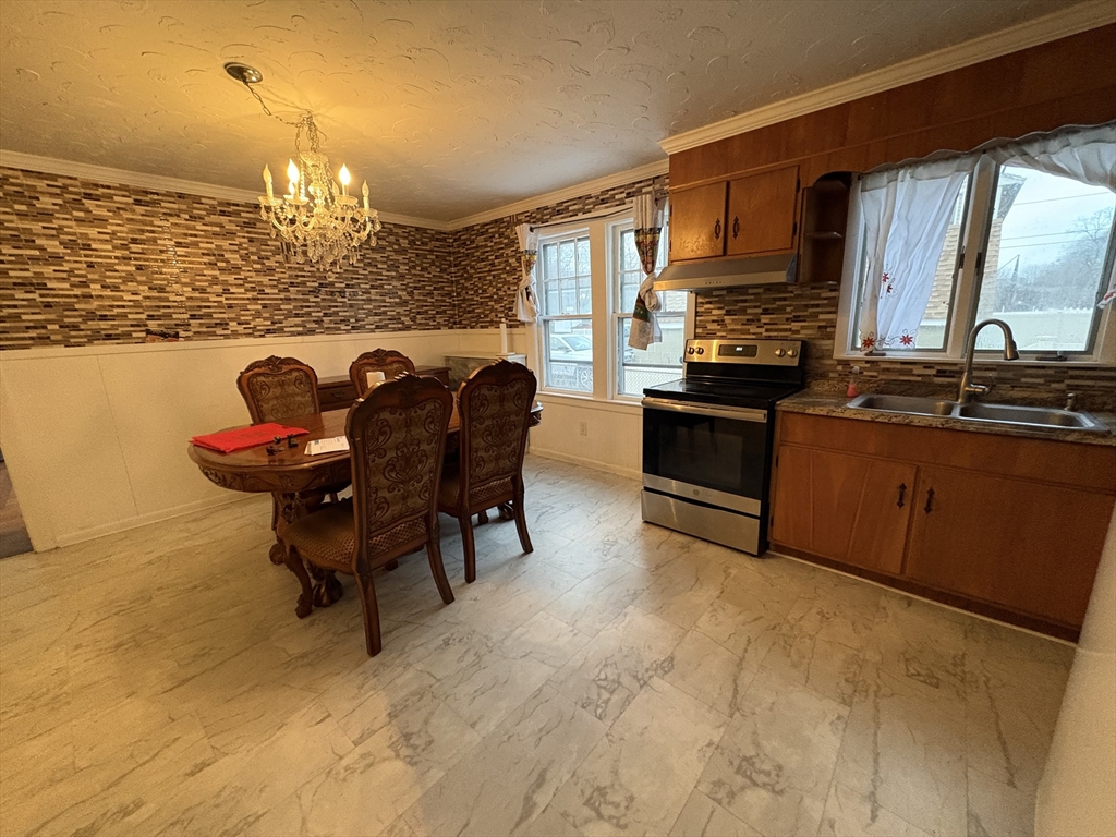 41 Amesbury Street Worcester, MA 01605 - Photo 8 of 17 a kitchen with cabinets and chairs