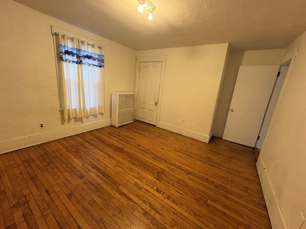 41 Amesbury Street Worcester, MA 01605 - Photo 10 of 17 a view of an empty room with wooden floor and a window