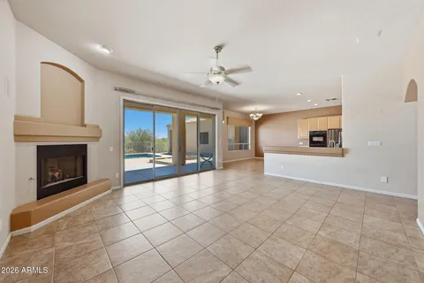 a view of a livingroom with a fireplace and window
