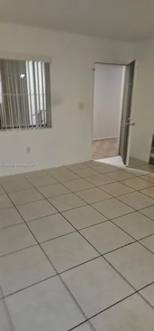 a view of an empty room and a window