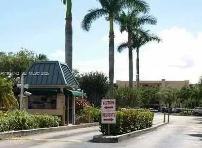 a front view of multi story residential apartment building with a garden