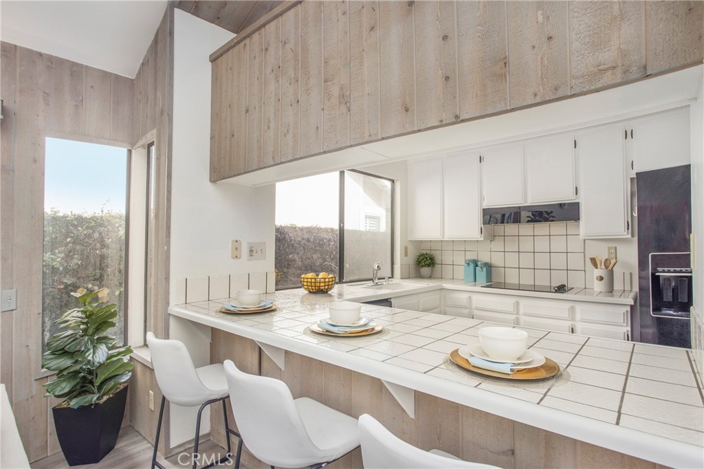 11 Ensueno Irvine, CA 92620 - Photo 13 of 36 a kitchen with a table and chairs in it
