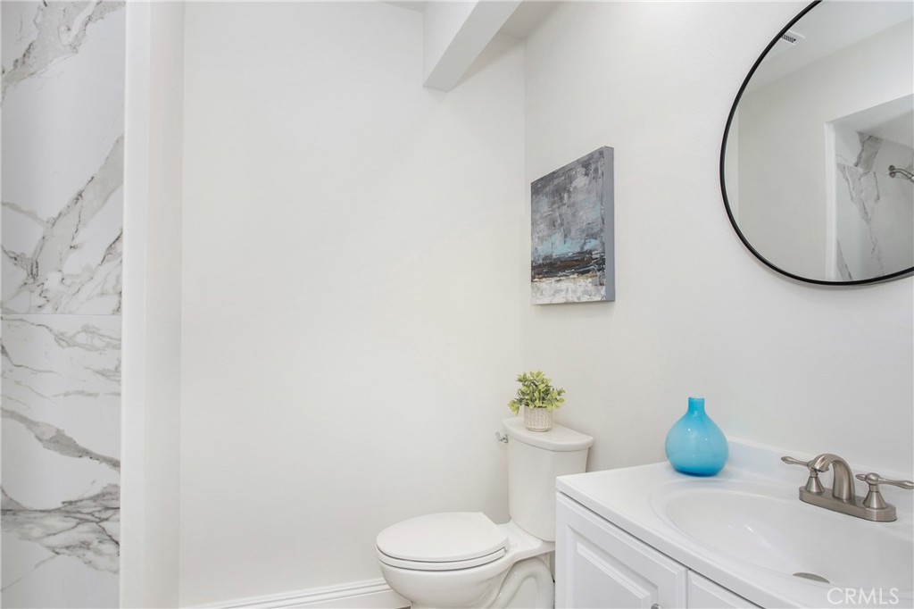 11 Ensueno Irvine, CA 92620 - Photo 18 of 36 a bathroom with a toilet sink and mirror